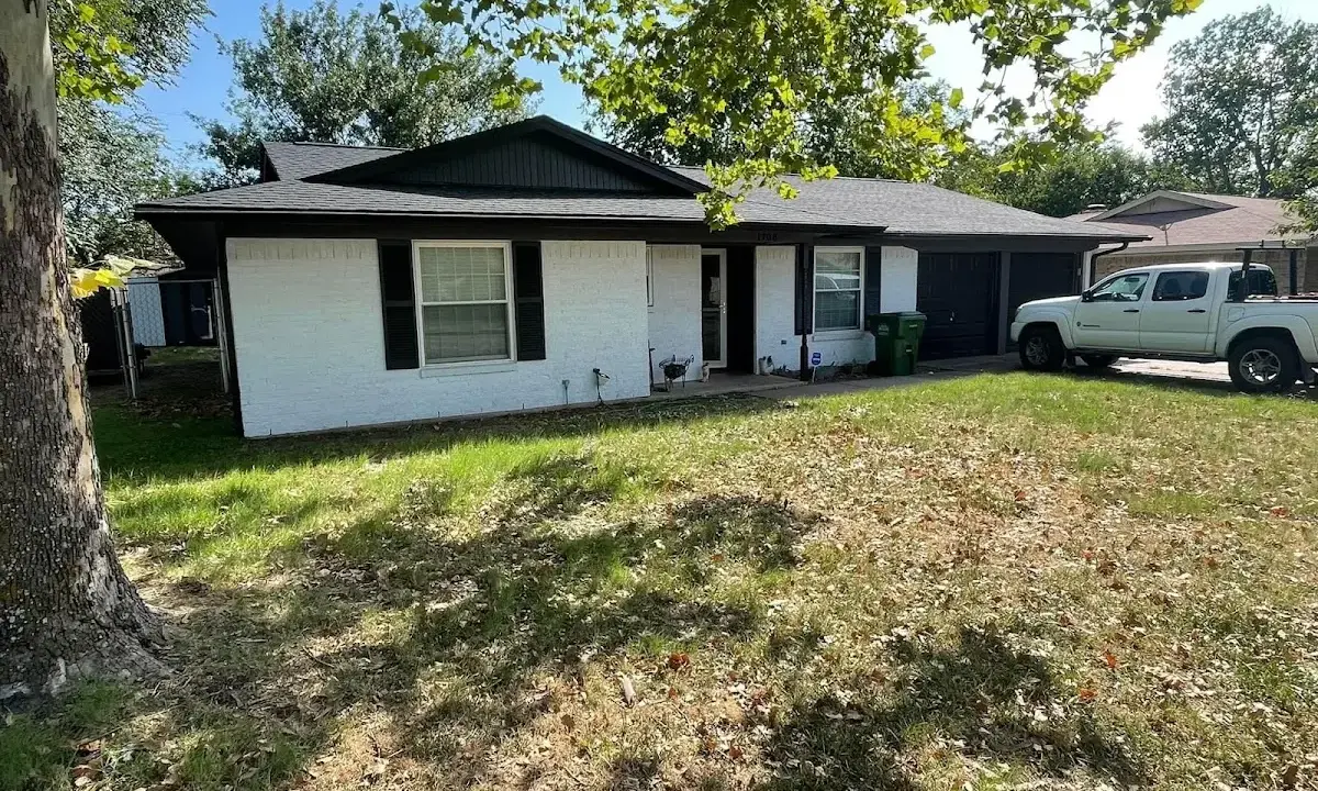 Professional roofing crew working on a residential roof in Stanton